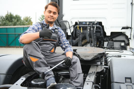Indian Mechanic repairing the truck photo
