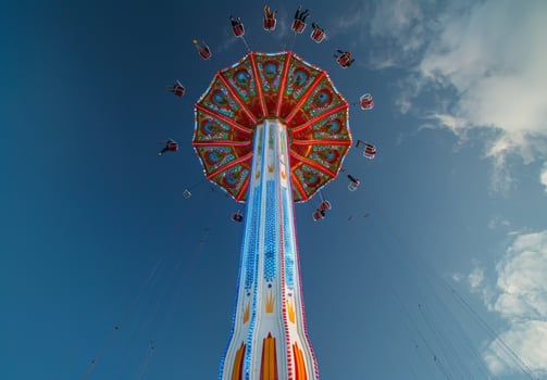 A carnival ride with people flying in the air photo