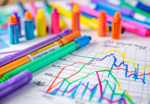 Colorful pens and graph paper on a desk photo