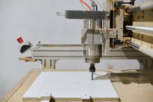 Close-Up of CNC Machine Precisely Cutting and Processing Wooden Boards photo