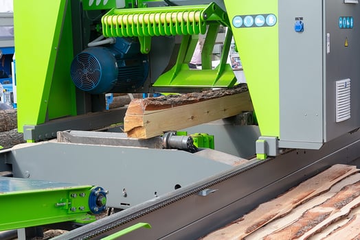 The process of sawing wood on sawmill equipment. Timber industry photo