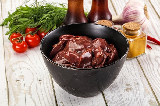Raw chicken liver uncooked in the bowl photo