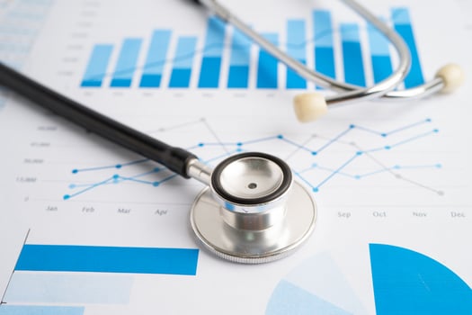 Stethoscope on spreadsheet and graph paper, Finance, Account, Statistics, Investment, Analytic research data economy and Business company concept. photo