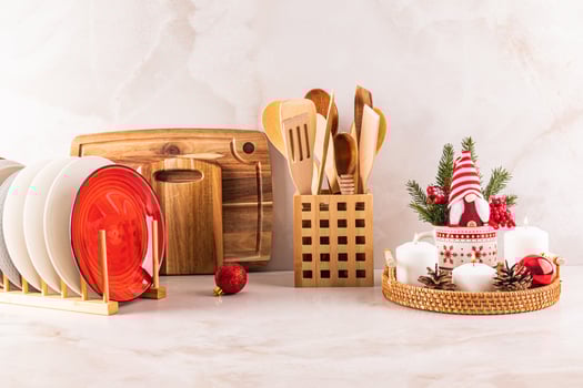Kitchen marble countertop decorated in a minimalist style for the New Year and Christmas. a dryer with plates, a set of candles, a New Year's gnome photo