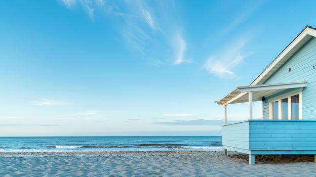 A peaceful beach house stands by the shore, reflecting the evening's mellow light photo