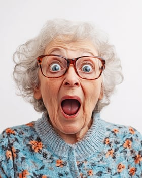 An older woman shows surprise and excitement with a joyful expression photo