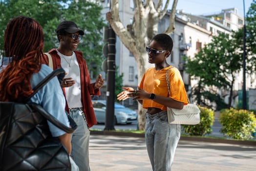 Happy carefree black young friends enjoy conversations as walk city streets, create joyful memories. photo