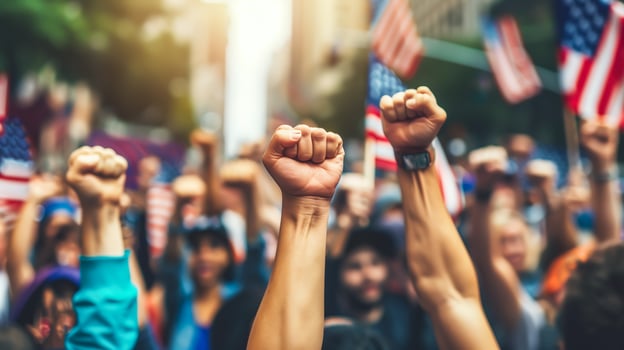 A group of protesters raise their fists in the air. . photo