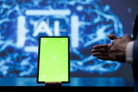 Engineer in startup doing advancements in AI field using mockup tablet. Close up of isolated screen device used by man working in cutting edge workspace featuring artificial intelligence photo