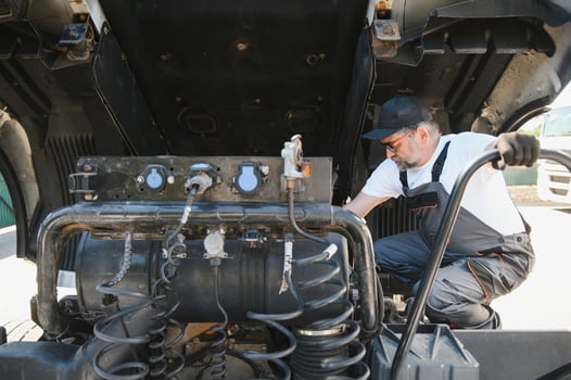 A senior worker checks wheel. Truck malfunction. Service work photo