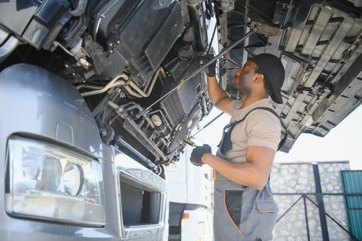 African american Professional Truck Mechanic Rebuilding Heavy Duty Truck Diesel Engine. Automotive Industry Theme photo