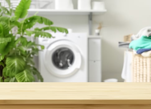 Wood table for display products on background of blurred laundry room photo