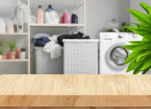 Wood table for display products on background of blurred laundry room photo