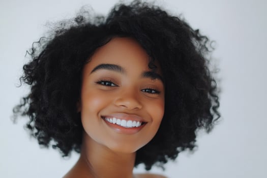 Smiling young woman with sock curls in a white studio. photo