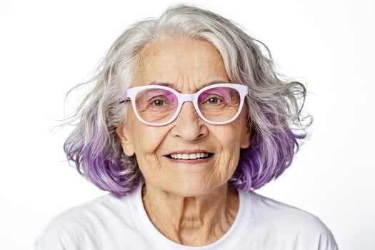 Portrait of a smiling senior woman with purple hair photo