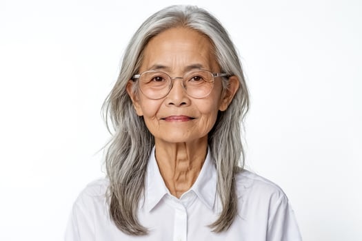 Portrait of a smiling senior woman with grey hair wearing glasses photo