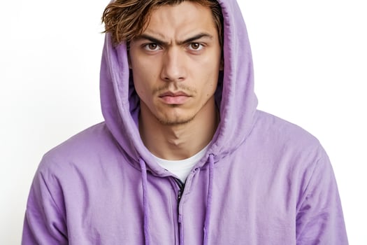 Serious Young Man Wearing Purple Hoodie photo