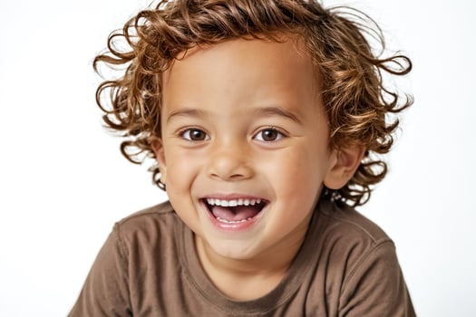 Joyful Little Boy with Curly Hair Smiling photo