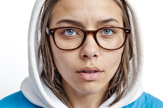 Close Up Portrait of a Young Woman in a Hoodie with Glasses photo