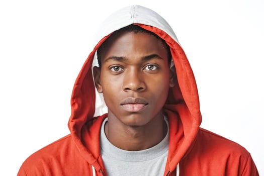 Young man with serious expression in red hoodie photo