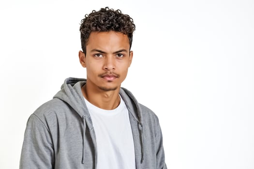 Young man with curly hair wearing a grey hoodie photo