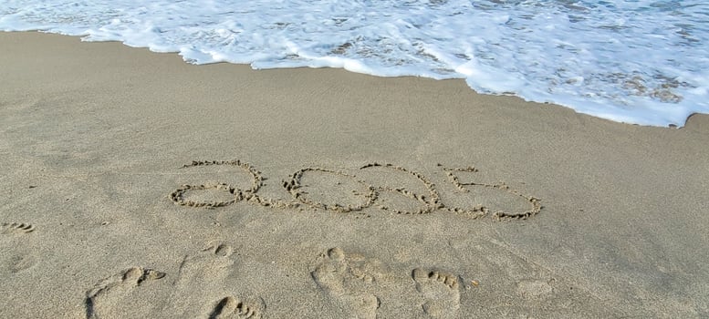 happy 2025 written in the sand of itamambuca ubatuba beach photo