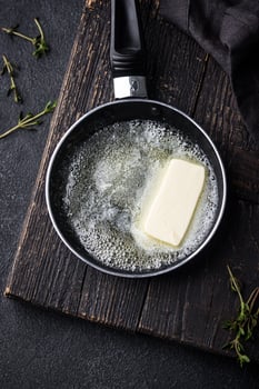 Melted butter on in iron pan photo