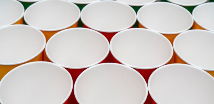 Multicolored disposable paper cups for drinks. photo