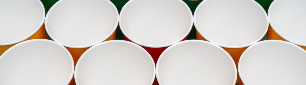 Multicolored disposable paper cups for drinks. photo