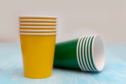 Multicolored disposable paper cups for drinks. photo