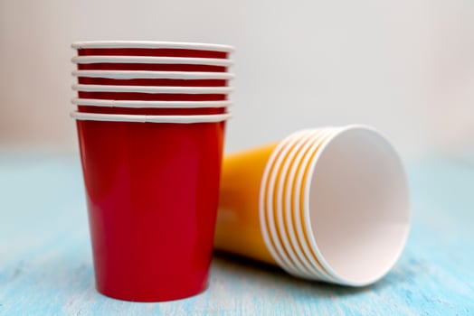 Multicolored disposable paper cups for drinks. photo