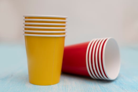 Multicolored disposable paper cups for drinks. photo