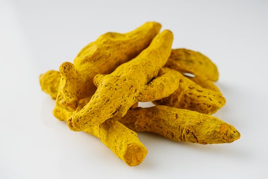 aromatic turmeric root on a white acrylic background photo