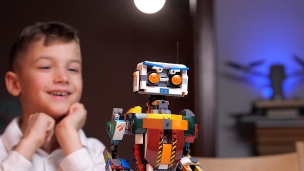 Child playing with programmable ai robot toy at home photo
