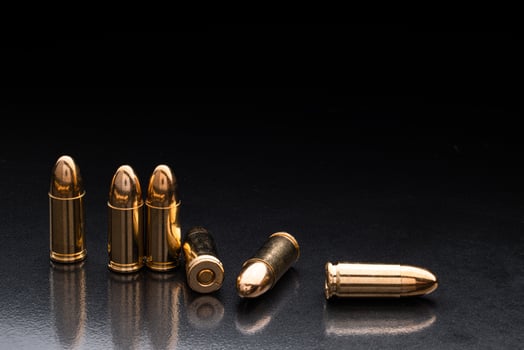 Bullet isolated on black background with reflexion. Rifle bullets close-up on black back. Cartridges for rifle and carbine on a black. photo