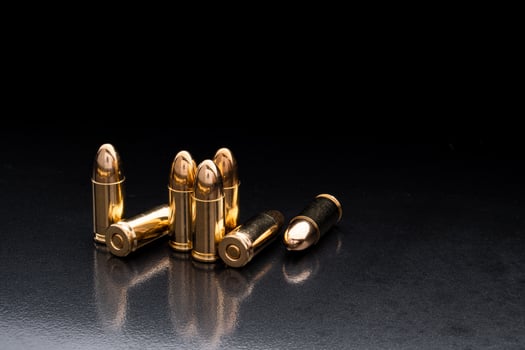 Bullet isolated on black background with reflexion. Rifle bullets close-up on black back. Cartridges for rifle and carbine on a black. photo