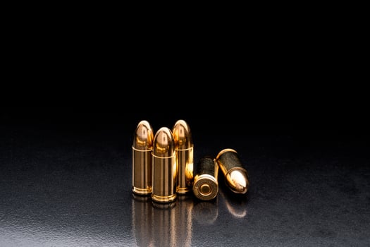 Bullet isolated on black background with reflexion. Rifle bullets close-up on black back. Cartridges for rifle and carbine on a black. photo