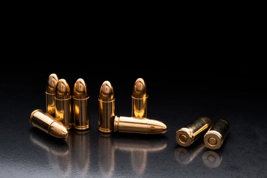 Bullet isolated on black background with reflexion. Rifle bullets close-up on black back. Cartridges for rifle and carbine on a black. photo