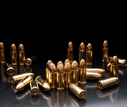 Bullet isolated on black background with reflexion. Rifle bullets close-up on black back. Cartridges for rifle and carbine on a black. photo