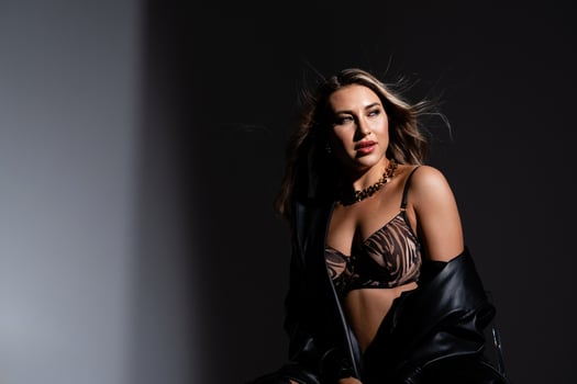 Model with long flowing hair and bare breasts in lingerie photo