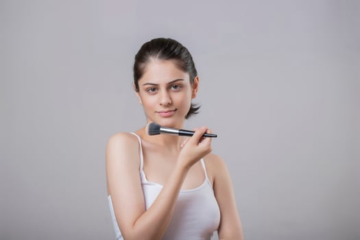 Young Fashion Model Showing Her Makeup Brush photo
