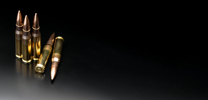 Bullet isolated on black background with reflexion. Rifle bullets close-up on black back. Cartridges for rifle and carbine on a black. photo