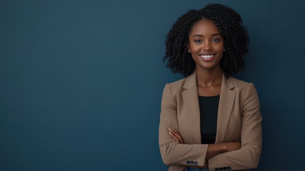 Professional woman with curly hair standing confidently against a blue wall in a business suit photo