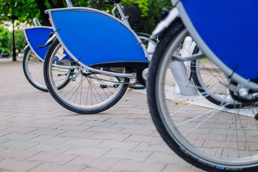 Bicycles for rent are parked in a row. An environmentally friendly and popular form of transport. photo