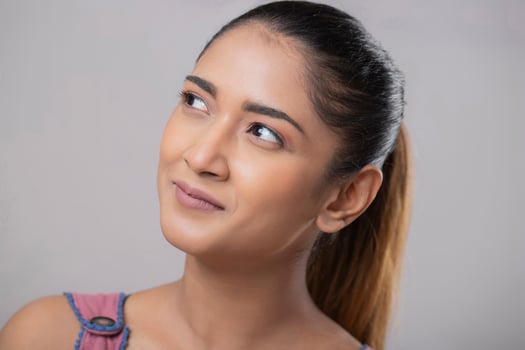 An Attractive Brown-Haired Woman Smiling And Contemplating Something photo