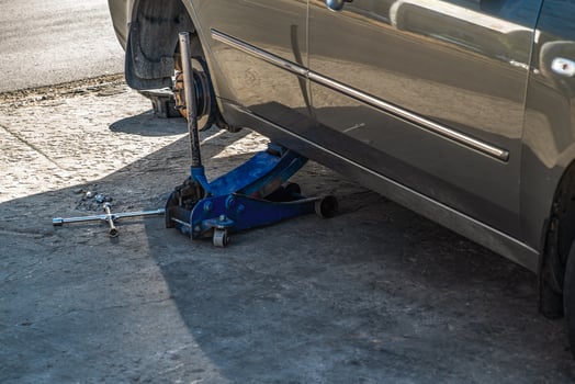 Replacing a wheel on a car. Car lifted on a jack for wheel repair. photo
