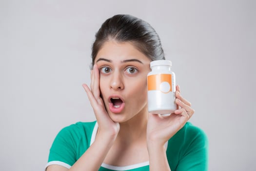 Indian Beautiful Female Holding Pill Bottle In Hand photo
