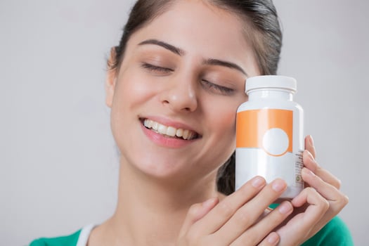Indian Beautiful Model Holding Bottle Pill In Hand photo