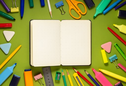 School office supplies on a desk with copy space. Back to school concept. School supplies on green background. Back 2 school concept photo