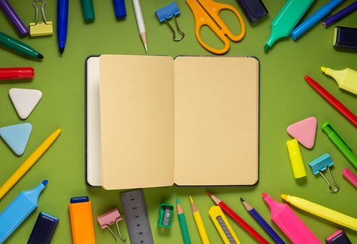 School office supplies on a desk with copy space. Back to school concept. School supplies on green background. Back 2 school concept photo